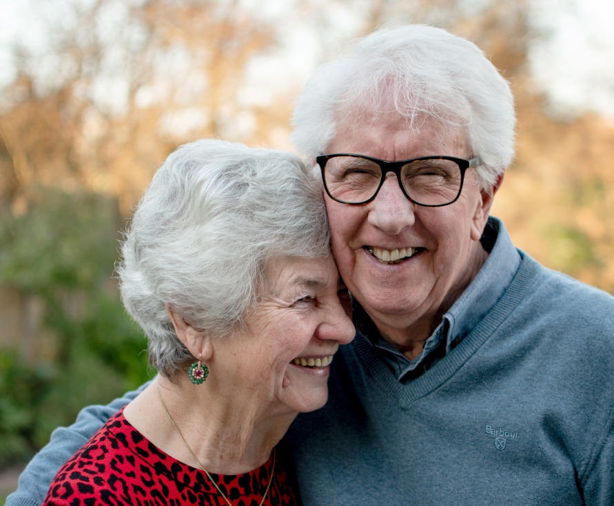 Senior man and woman smiling together outdoors
