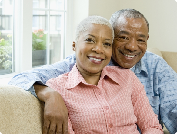Man and woman with dentrues smiling together