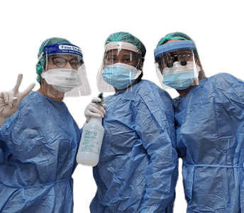 Three dental team members wearing protective equipment