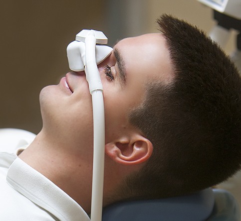 Man relaxed with nitrous oxide dental sedation mask
