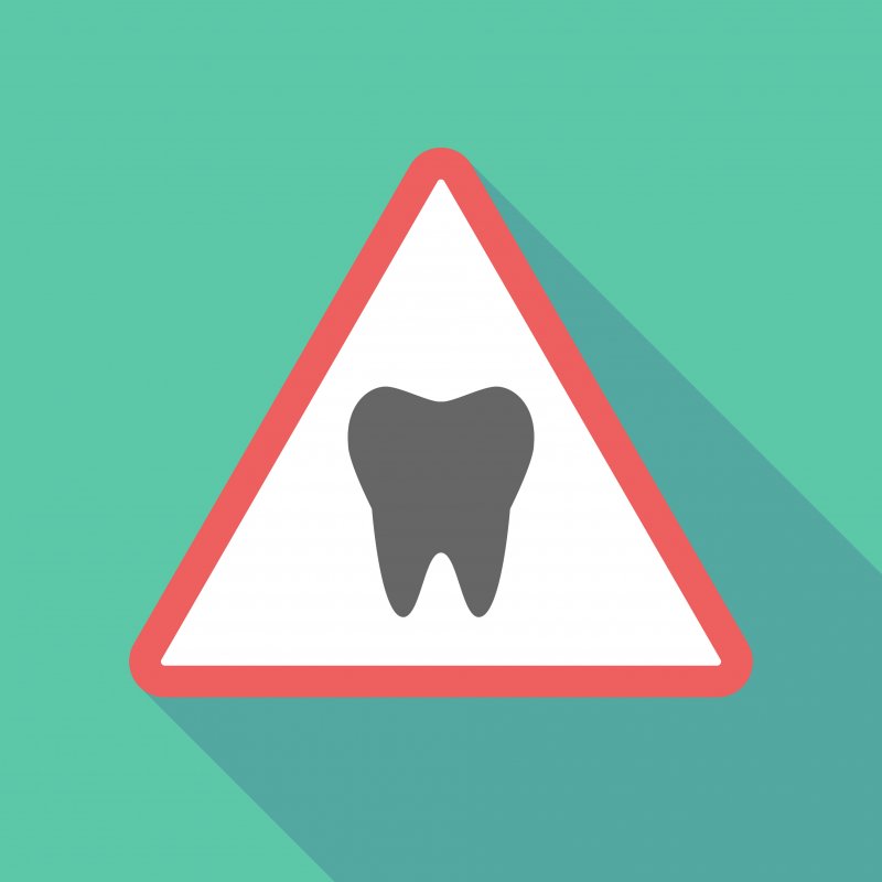 Triangular warning sign with tooth in center
