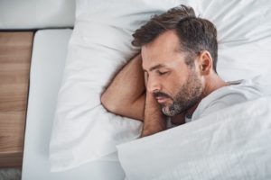 Man with beard sleeping in bed